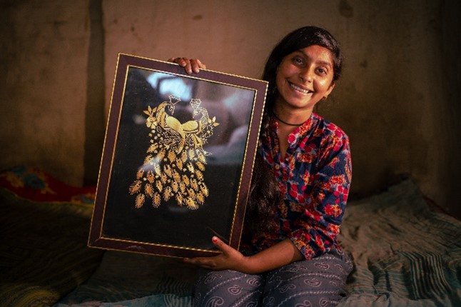 Rachna with one of her paintings