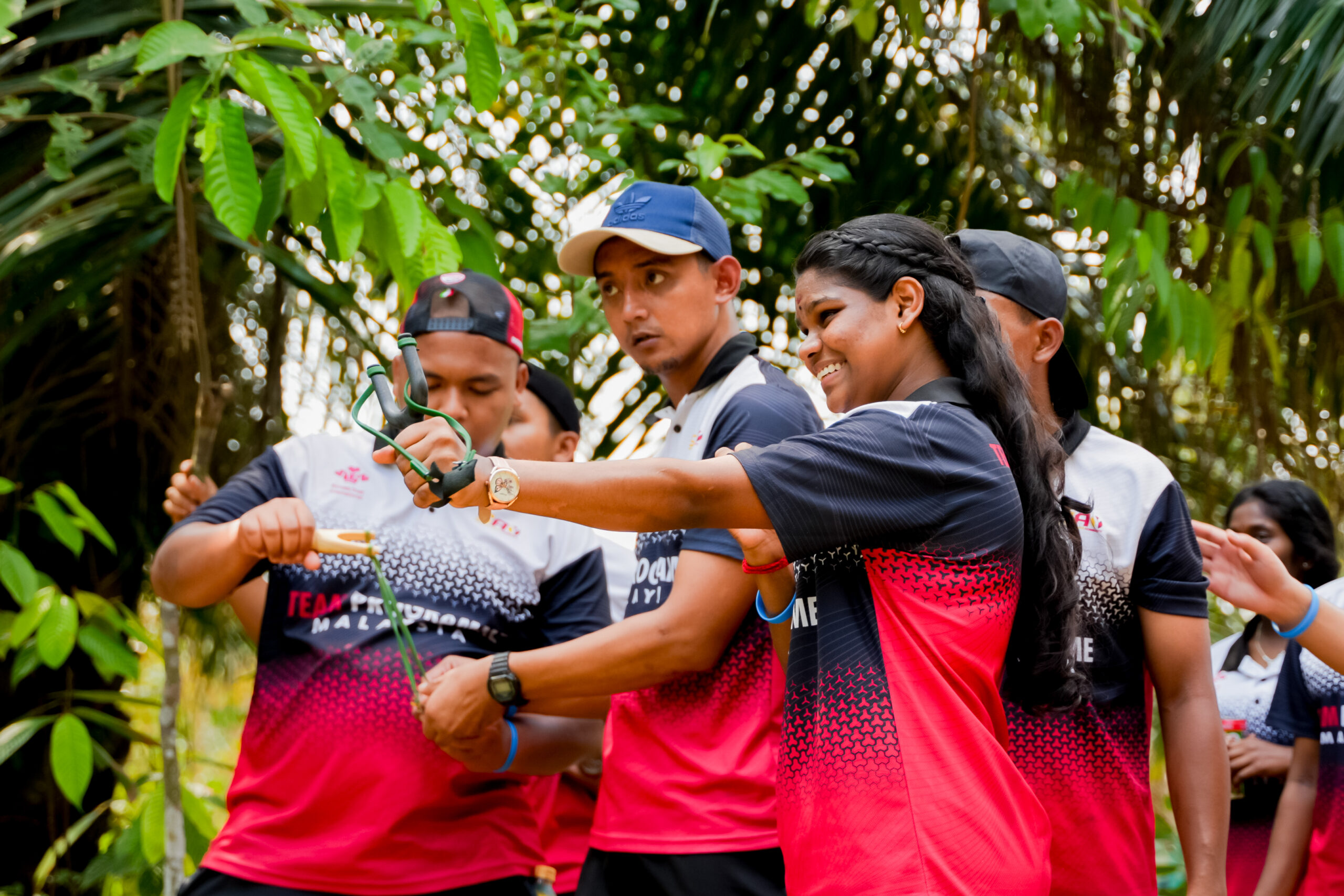 Young people aiming a slingshot at the Team Environment Day in Malaysia