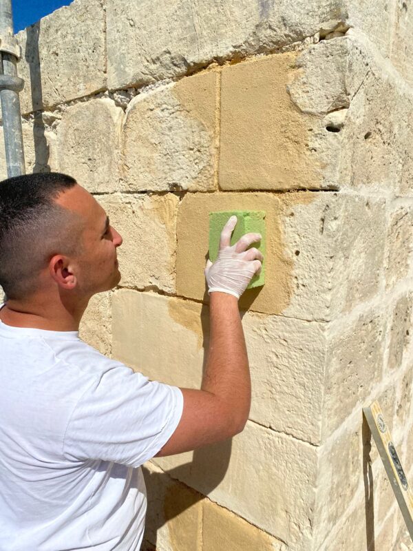 Andre working as a stonemason