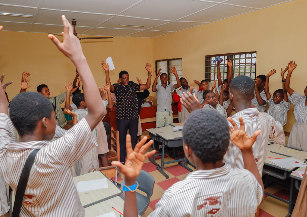 Students and teacher celebrating inside classroom in Ghana
